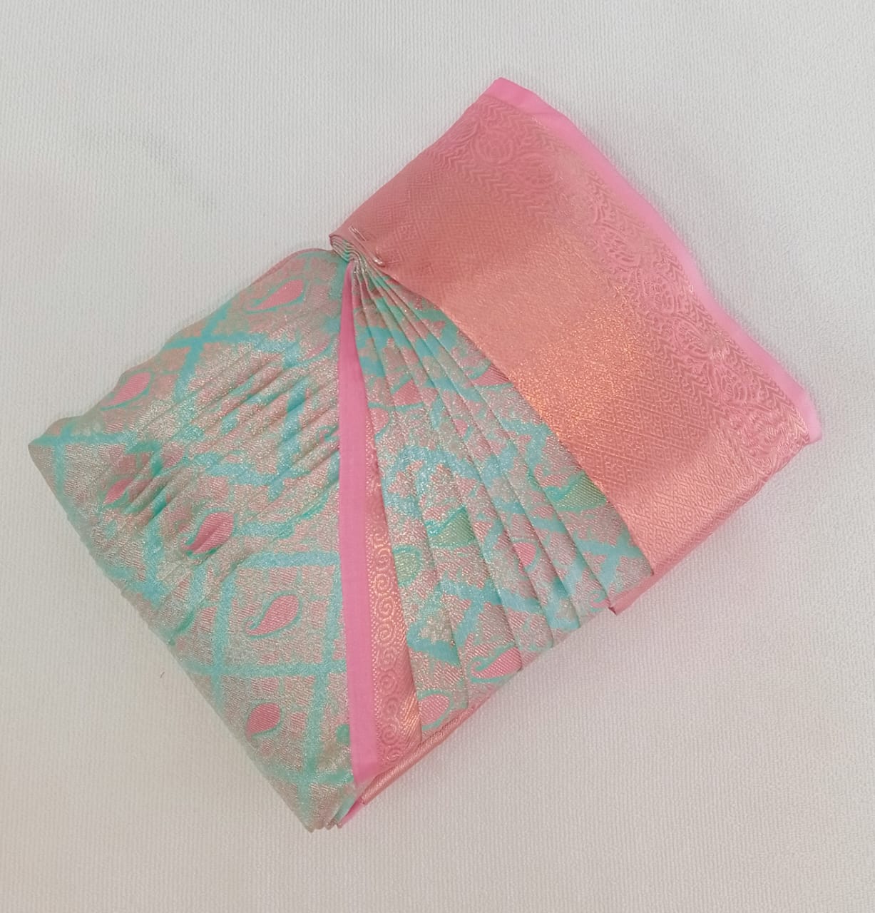 Close-up of fabric being meticulously pleated by hand.