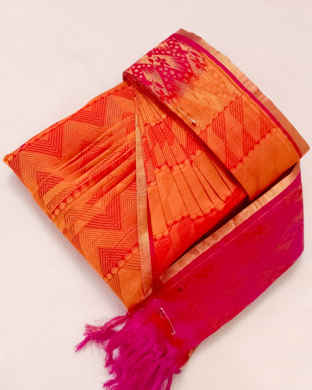 Detailed close-up showing perfectly aligned saree pleats.